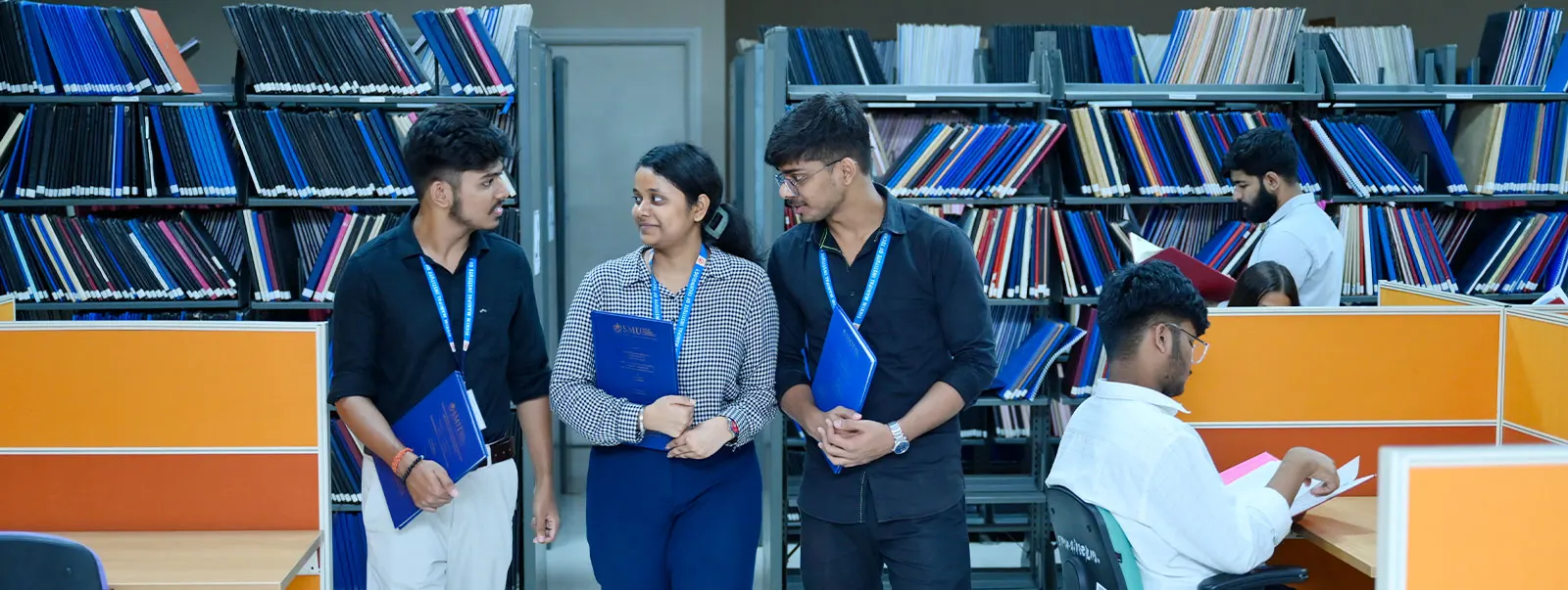Students in the library stacks at Sikkim Manipal University